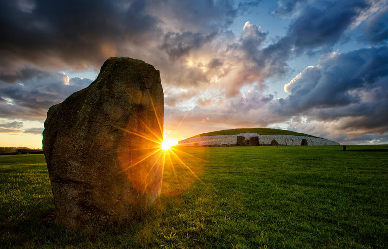 Sunrise illuminating the ancient passage tomb at Newgrange, County Meath, Ireland.